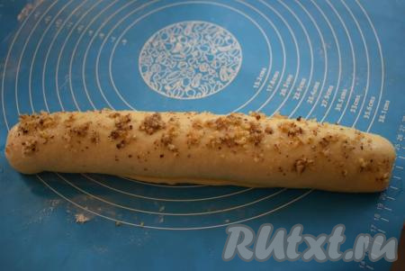 Оставшейся половиной яйца смазываем рулет сверху и&nbsp;посыпаем немного ореховой начинкой.