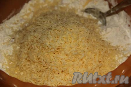 К смеси муки и колбасы добавить сыр, натёртый на мелкой тёрке.