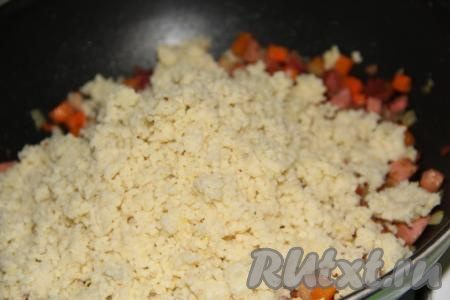 Затем к моркови, луку и колбасе выложить готовую пшённую кашу.