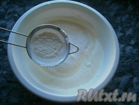 Теперь частями всыпать просеянную с разрыхлителем муку, аккуратно ложкой перемешивая тесто. Каждую порцию муки нужно полностью вмешать в яичную смесь.