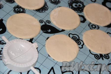 На припыленном мукой столе (или на силиконовом коврике) скалкой тонко раскатать тесто и вырезать стаканом кружочки. Вареники можно слепить, как обычно, руками, я решила сформировать вареники с помощью формочки.