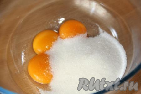 Желтки соединить с ванильным сахаром и оставшимся сахаром.