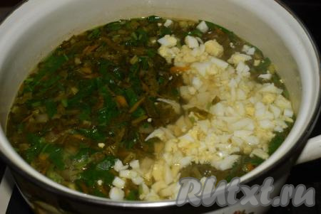 Добавляем нарезанные яйца и варим щавелевый суп до закипания.