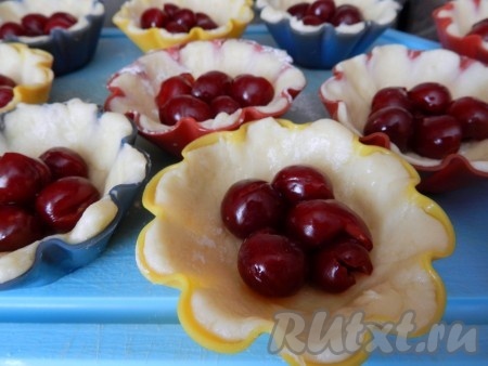 На тесто выложить вишню, очищенную от косточек.