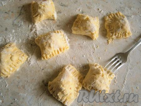 Нарезать тесто на части, вишня должна оказаться в центре вареника. Края защипнуть с помощью вилки.