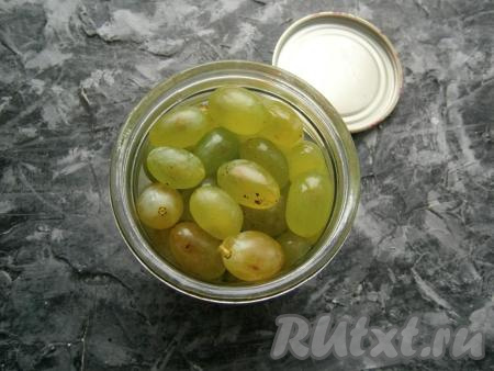 Банку наполнить ягодами винограда.