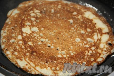 Жарить дрожжевой блин с двух сторон до золотистого цвета на среднем огне. В дальнейшем можно жарить блины, не смазывая сковороду маслом (растительное масло присутствует в блинном тесте). Таким образом пожарить все блинчики.