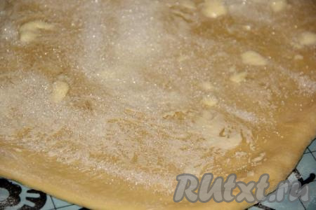 Смазать мягким маслом пласт теста и присыпать сахаром.