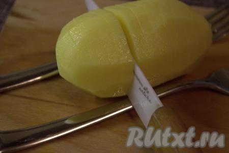 Острым ножом на поверхности каждой картофелины сделать поперечные надрезы на расстоянии,&nbsp;примерно, 0,5 сантиметра, не дорезая до конца. Удобно делать надрезы, положив картофелину между двух вилок или ложек (как на фото). Вилки (или ложки) станут "ограничителем", который поможет аккуратно надрезать клубень картофеля, не разрезав его полностью.