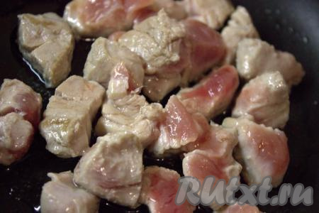 В сковороде разогреть растительное масло, выложить кусочки свинины, обжаривать мясо на сильном огне 2-3 минуты, периодически переворачивая.