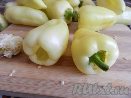 Прежде всего нужно сварить рис, для этого нужно его промыть, выложить в кастрюлю с кипящей подсоленной водой, а после повторного закипания воды перемешать рис и варить на небольшом огне до готовности (минут 20), затем лишнюю воду слить, оставить рис до полного остывания. Болгарский перец вымыть, очистить от плодоножек и семян. У нас на юге принято не вырезать плодоножку, а вдавливать её внутрь перца и затем вытаскивать вместе с семенами.