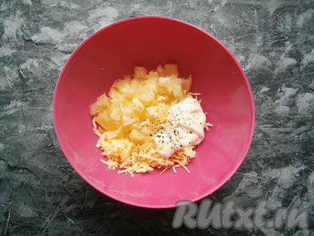 К сыру добавить нарезанные ананасы, пропущенный через пресс чеснок, майонез, немного соли и молотого чёрного перца.