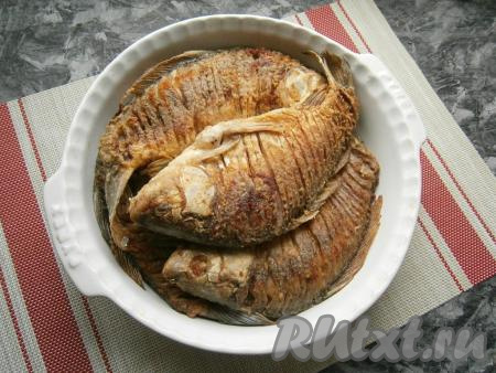 Каждую рыбку обвалять с двух сторон в муке и обжарить на разогретой с достаточным количеством растительного масла сковороде. Жарить нужно на довольно сильном огне до румяного цвета с двух сторон. Наша цель именно обжарить рыбу, то есть сделать румяную корочку, карасиков мы будем доводить до готовности&nbsp;в духовке. Жареных карасей сложить в большую форму для запекания или сковороду (сотейник).