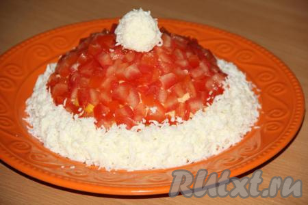 Белки натереть на средней тёрке. Большую часть натёртого белка выложить по низу салата, формируя опушку шапки Деда Мороза. В оставшиеся белки добавить несколько капель майонеза, сформировать руками шарик и поместить на верх салата (это помпончик).