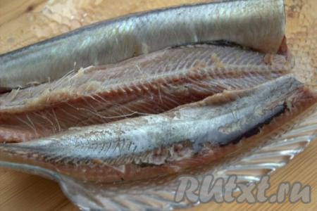 Промыть селёдку под&nbsp;проточной водой. Промытую рыбку обсушить бумажным полотенцем. Затем снять кожицу, разделать рыбу на филе, разрезав вдоль хребта, и удалить все крупные кости.