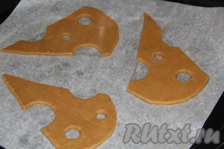 Раскатать готовое тесто в пласт толщиной, примерно, 5 мм. Вырезать из теста пряники произвольной формы. Я вырезала пряники в виде ломтиков&nbsp;сыра, дырочки сделала ножом. Противень застелить пергаментом, выложить пряники на противень.