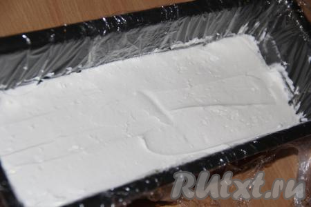 Выложить часть крема на печенье и разровнять.