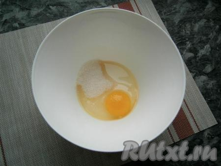 Яйцо разбить в миску, всыпать щепотку соли и сахар.