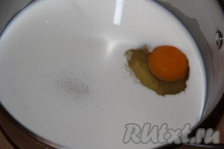 В толстостенную кастрюлю влить молоко и добавить яйцо.