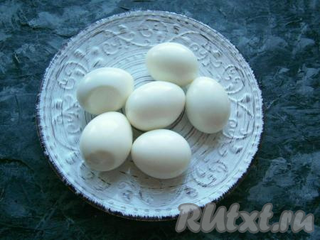 Яйца отварить в кипящей воде около 10 минут, остудить их в холодной воде и очистить.