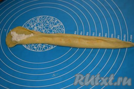 На середину овала выкладываем, примерно, 1 чайную ложку творожной&nbsp;начинки и защипываем края, формируя трубочку.