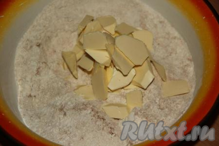 Слегка перемешать сухие ингредиенты. Размягчённое сливочное масло порубить ножом и выложить в миску с сухими ингредиентами.