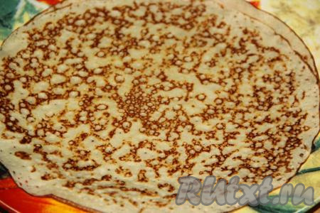 Жарить блин с двух сторон до золотистого цвета на среднем огне, затем переложить на тарелку. Аналогично пожарить все кружевные блинчики на сковороде, складывая их стопочкой на тарелку.