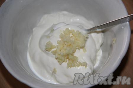 Пока курочка остывает, приготовить сметанно-чесночный соус для бургеров, для этого нужно соединить сметану с пропущенным через пресс чесноком, слегка посолить.