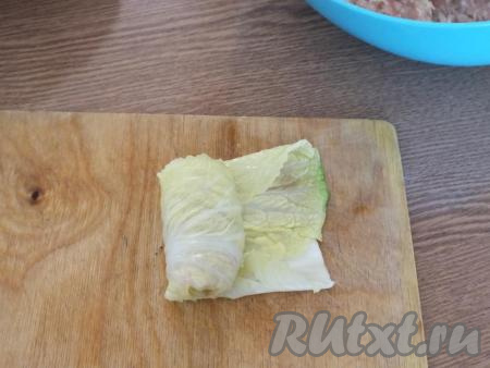 Подогните края листочка внутрь и закручивайте голубец "рулетиком" (как на фото).