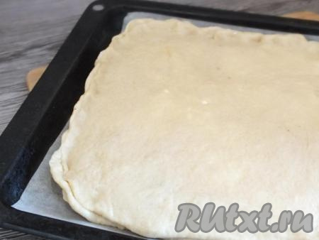 Раскатайте второй пласт теста и накройте начинку. Защипните края пирога.