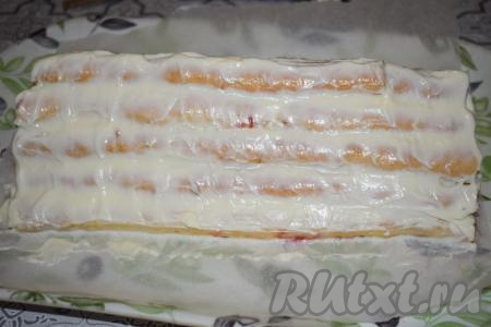 Смазываем весь торт "Монастырская изба" сверху оставшимся сметанным кремом и немного его разравниваем.