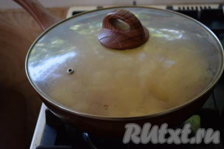 Далее накрываем сковороду крышкой и жарим молодую картошку на огне чуть выше среднего, примерно, 7-8 минут.
