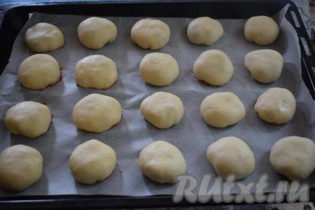 Противень застилаем пергаментом и выкладываем наши клубничные булочки на расстоянии друг от друга швом вниз.