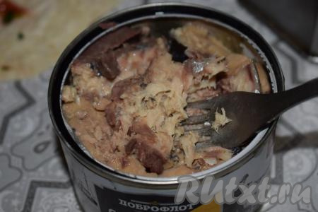 Разминаем вилкой рыбные консервы, удалив предварительно крупные косточки из кусочков.