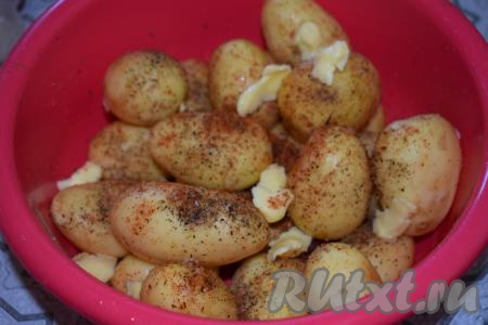 В миску с молодой картошкой влить растительное масло, добавить кусочки сливочного масла комнатной температуры.