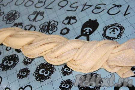 Переплести две части теста в косичку. Можно оставить плетёнку в таком виде, я сформировала из плетёнки круг.