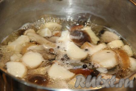 В приготовленный маринад, не снимая его с огня, выложить отваренные лесные грибы, довести до кипения и убавить огонь до минимума.