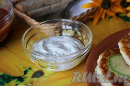 Оладушки с кабачками я подала к столу с соусом из сметаны и рубленой зелени.