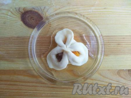 На блюдце налить растительное масло, нижнюю часть каждого манта окунуть в масло.