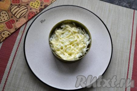 Яйцо разделить на белок и желток. На ананас, смазанный майонезом, выложить натёртый на тёрке белок, который смазать майонезом.