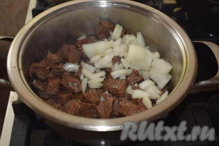 Лук и морковь очищаем от кожицы и нарезаем на полоски. Болгарский перец очищаем от плодоножки с семенами и также режем на полосы. В кастрюлю к мясу добавляем сначала лук, перемешиваем. Жарим говядину с луком до прозрачности лука (примерно, 7-8 минут).