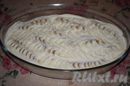 Далее верх десерта покрываем слоем крема и, по желанию, делаем бороздки при помощи чайной ложки.