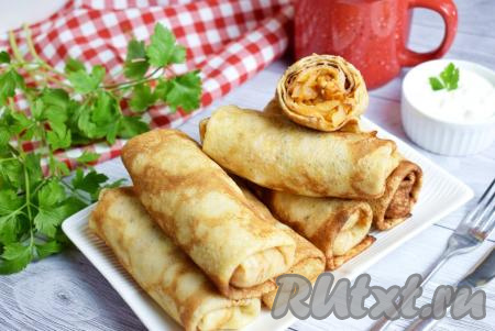 Блины, фаршированные тушёной капустой и фаршем, готовы, к столу подавайте тёплыми, дополнив сметаной.