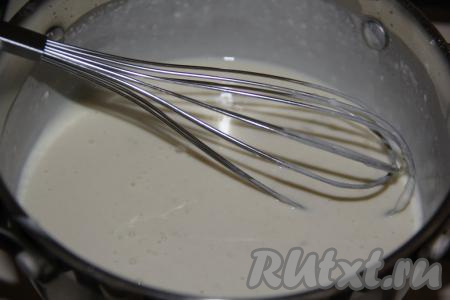 Затем добавлять молоко маленькими порциями и тщательно перемешивать венчиком.