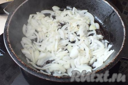 В жаровне (или подходящей сковороде) разогрейте растительное масло, выложите лук и обжаривайте на среднем огне, помешивая, в течение 7 минут (до появления лёгкого румянца).