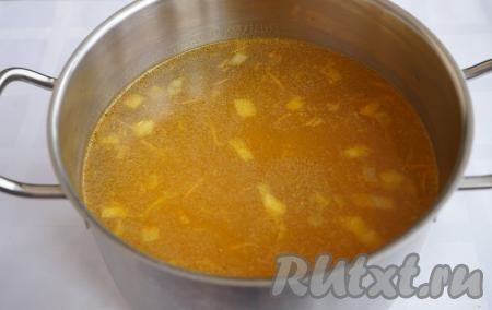 Проверяем готовность бульона (а точнее курицы в бульоне). Если при прокалывании окорочка шпажкой (или ножом) сочится только прозрачный сок, то можно снимать кастрюлю с бульоном с огня. Окорочок из бульона достаём и отставляем в сторону (мы его будем использовать уже при подаче). Я рекомендую процедить бульон через сито и сложенную втрое марлю. Теперь наш бульон стал абсолютно прозрачным и аппетитным. Для приготовления этого супа-пюре нам потребуется отмерить 1,5 литра готового бульона. В кастрюлю с 1,5 литрами куриного бульоном добавляем обжаренные овощи.