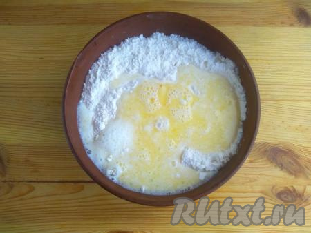 Тёплую масляно-молочную смесь влить в мучную смесь, перемешать, замешивая тесто.