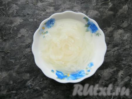 Лук репчатый очистить, нарезать тонкими полукольцами, выложить в небольшую тарелочку, добавить лимонную кислоту и сахар, залить кипятком и оставить для маринования на 10 минут.