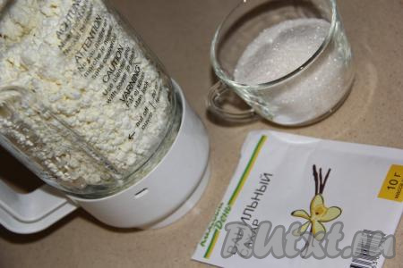 Пока корж в холодильнике, приготовим творожную начинку, для этого в чашу блендера нужно выложить творог, всыпать сахар, крахмал и ванильный сахар. 