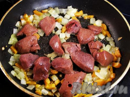 В сковороду с обжаренными овощами выкладываем кусочки свиной печени, слегка посыпаем солью, перемешиваем и жарим на среднем огне, помешивая, примерно, 10 минут (до готовности печёнки). Готовность печёнки проверить достаточно просто, нужно разрезать кусочек печени и убедиться в том, что в разрезе и в выделившемся соке нет примесей крови.